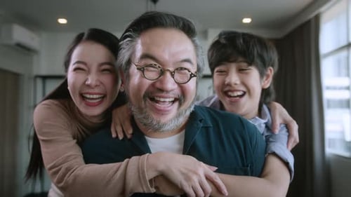 Happy Family Laughing Together at Home