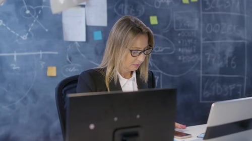 Woman Working on Computer in a Corporate Office