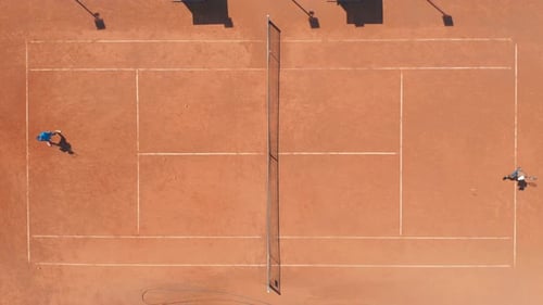 Professional Tennis Players Playing on Red Clay Court. Aerial Top Down Drone View