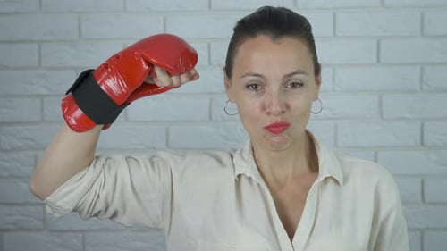 Confident Woman Raises Boxing Glove Triumphantly