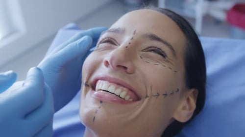Woman Smiling with Black Markings on Her Face
