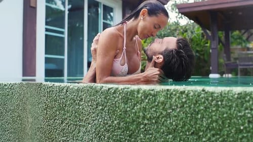 Romantic Couple Kissing in Tropical Swimming Pool