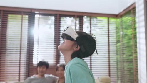 Boy Using VR Headset at Home with Family