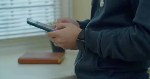 Man Hands Using a Smart Phone, Close Up. Young Man Holding Mobile Smart Phone. Guy Using Mobile