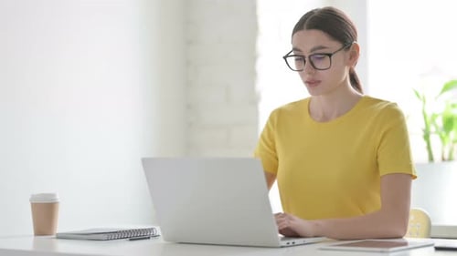 Busy Woman Using Laptop in Office