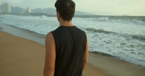 Walk on the Sand on Beach at Sunset Against the Backdrop of the Beautiful Sea Big Beautiful Waves