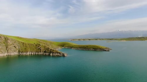 Aerial view of a reservoir with fresh water with the mountains in the background