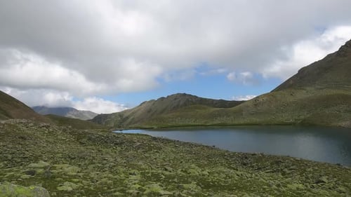 Timelapse lake scenes in mountains with beautiful clouds moving fast in national park of Dombay