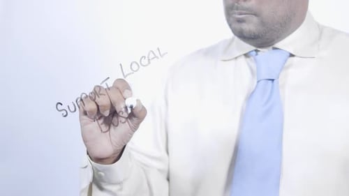 Writing "Support Local Business" on Clear Surface