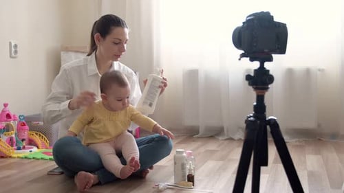 Young Mother with Little Boy Recording Video on Camera and Vlogging About Family and Childhood