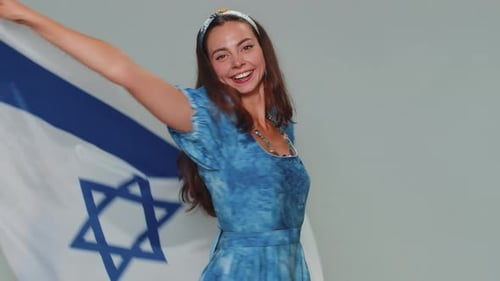 Smiling Woman Waving National Flag Indoors