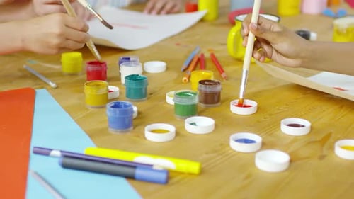 Close Up of Hands of Kids Painting with Gouache