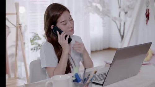 Woman Working from Home on Laptop and Mobile