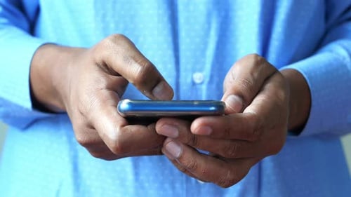 Close Up of Young Man Hand Using Smart Phone.
