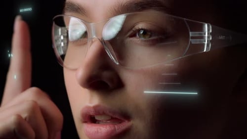 Young Adult Interacting with Holographic Charts and Graphs