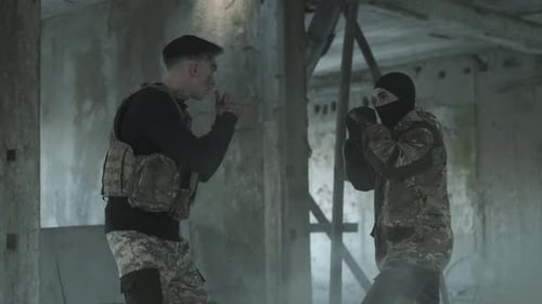 Two Adults Sparring in Derelict Building