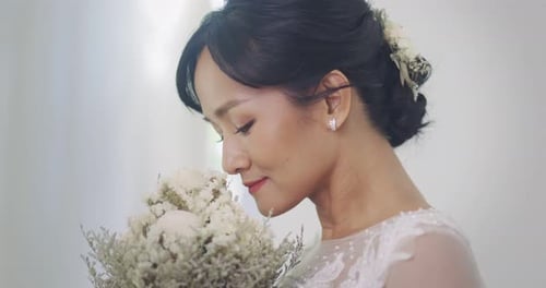 Bride Holding White Flower Bouquet in Natural Light