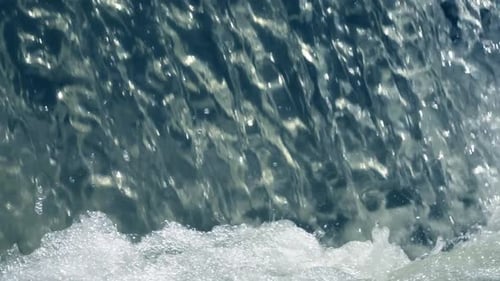 Cascading Water Creating Bubbles in Sunny Environment