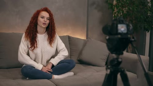 Young Woman Talking to Camera on Couch