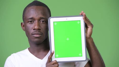 Young Adult Presenting Green Screen Tablet