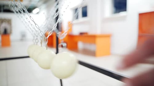 Balancing balls of Newton's cradle. Museum of Science