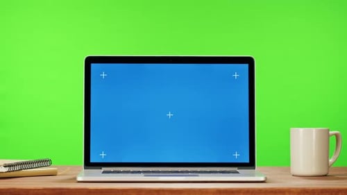 Laptop with Blue Chroma Key on Green Background Closeup