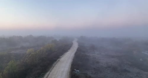 Aerial Top View of Sky Road Over Top of a Flat Ground with Fog and Green Jungle