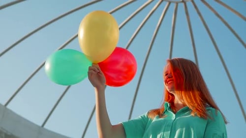 Woman with Balloons Smiling on a Sunny Day