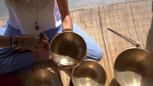 Woman Plays Singing Bowls for Meditation and Healing
