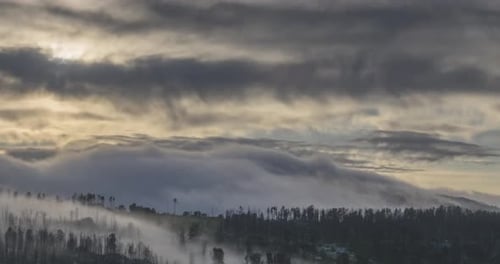 Sunrise Over Mountain Landscape With Drifting Mist