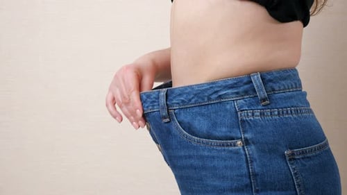Woman Showing Weight Loss Success Jeans