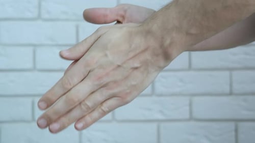 Spraying and Rubbing Hand Sanitizer for Cleanliness