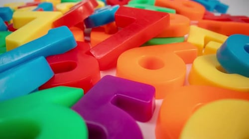 Colorful Plastic Numbers Piled Close Up