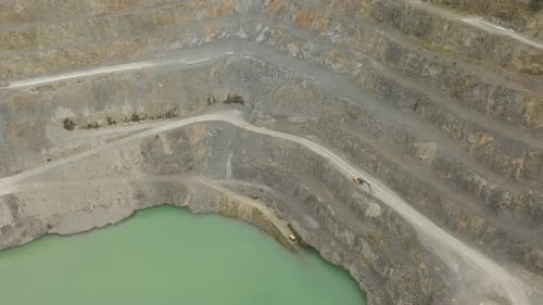 Aerial perspective of quarry interior including roads and machinery.