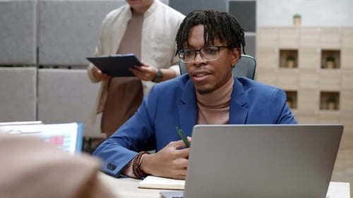 Man Discussing Data at Corporate Office Meeting