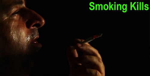 Man Smoking a Cigarette in the Dark