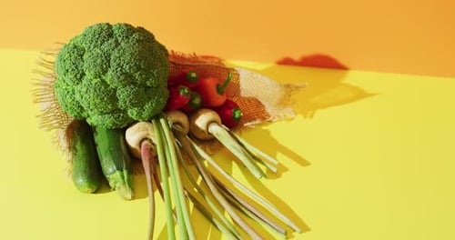 Video of fresh vegetables with copy space over yellow background