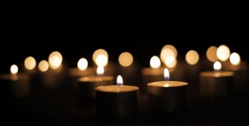 Many Tea Light Candles Flickering in the Dark