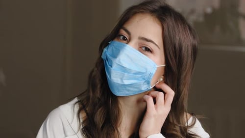 Portrait of Beautiful Brunette Woman Patient Girl Takes Off Protective Medical Mask From Female Face