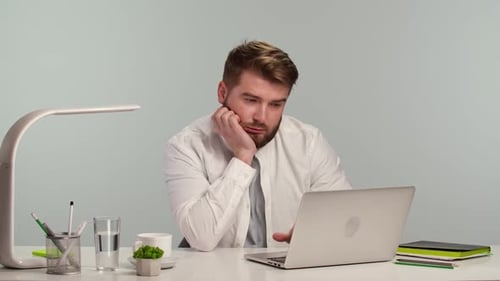Young Man Freelance Student Using Laptop Studying Online Work From Home on the Internet