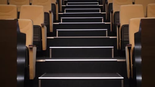 Empty Auditorium with Chairs and Glowing Steps