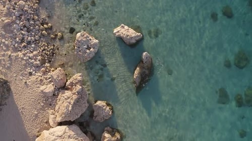 Aerial View of Tropical Beach with Crystal Clear Water and Stones