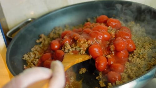 Adding Tomatoes and Sauce to Ground Meat in Pan