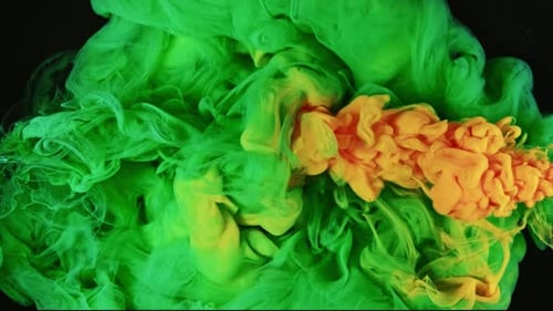 Green and Orange Ink Swirling Abstractly