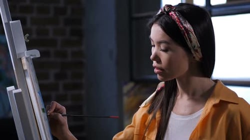 Woman Painting on Canvas in Studio
