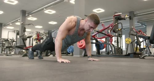 Athletic Man Doing Push Ups at Modern Gym