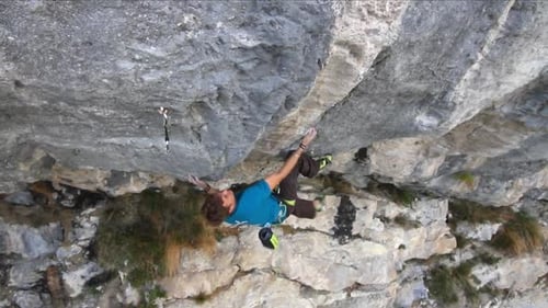 A man rock climbing up a mountain.