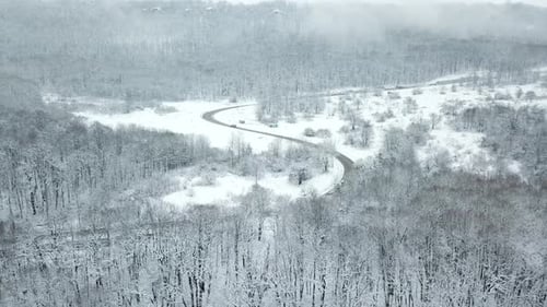Drones Eye View Winding Road From the High Mountain Pass in Winter