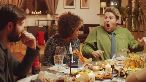 Friends Enjoying Dinner Party in Warmly Lit Home