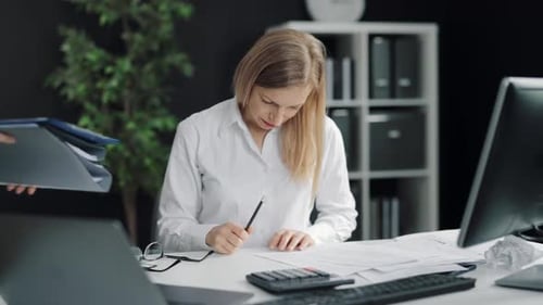 Stressed Woman Working with Paperwork in Office
